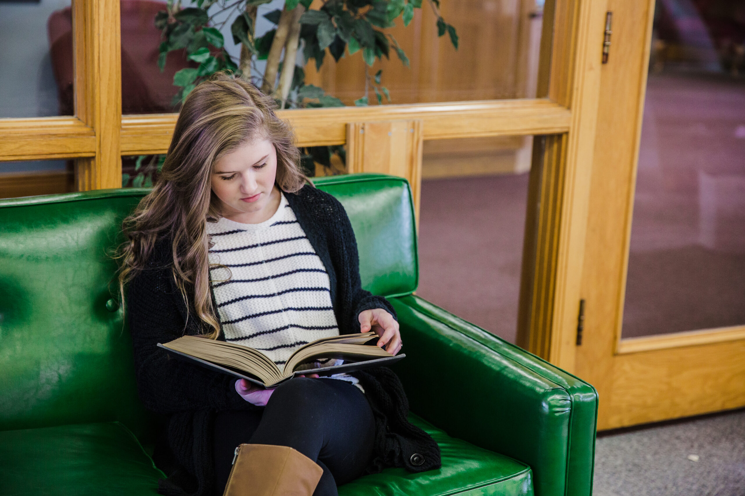 Haley Shepard reading a book in the library