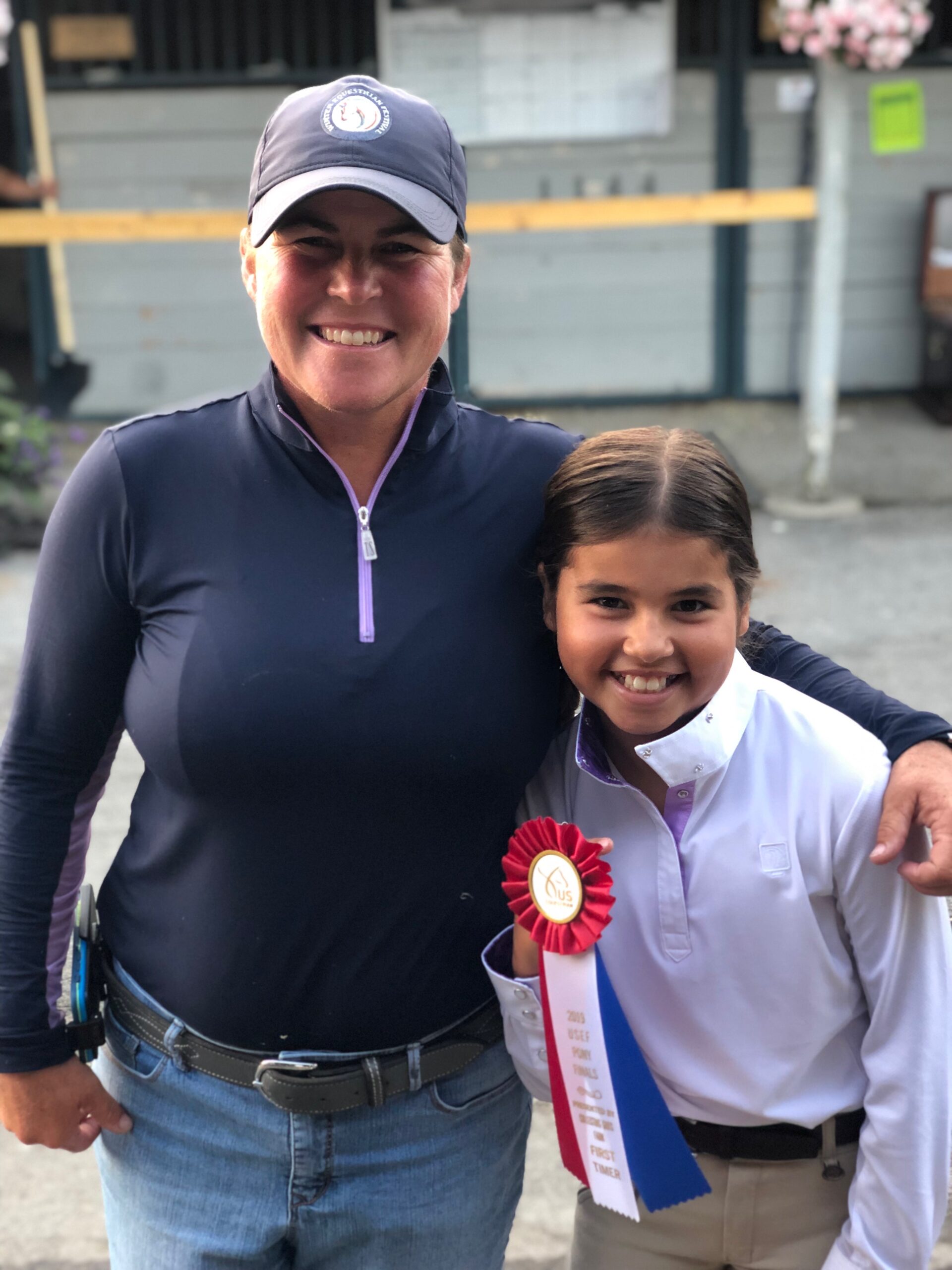 Picture of Patti with a student and a ribbon