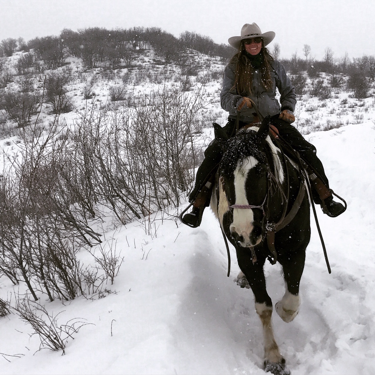 Mandy Griffey riding western on a horse in Colorado
