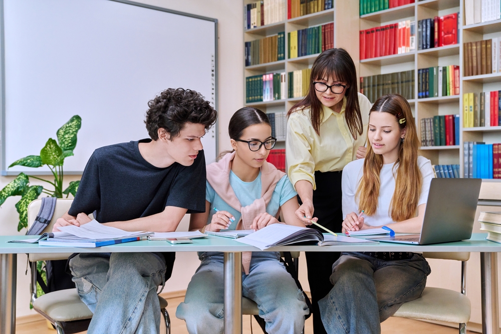 Group,Of,Teenage,Students,With,Female,Teacher,Study,Inside,Classroom